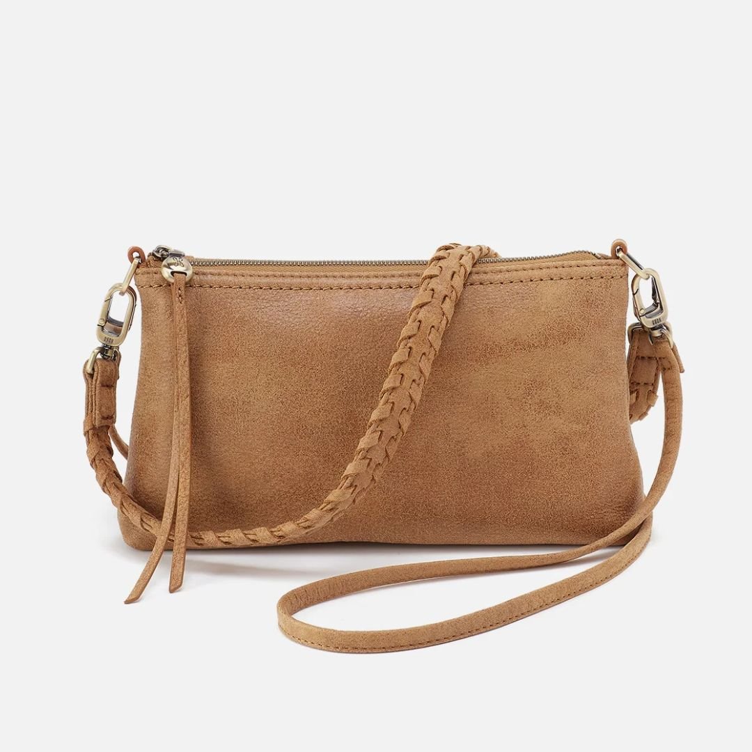 Brown leather crossbody bag with braided strap on a white background