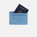 Blue passport holder with a passport inside on a white background