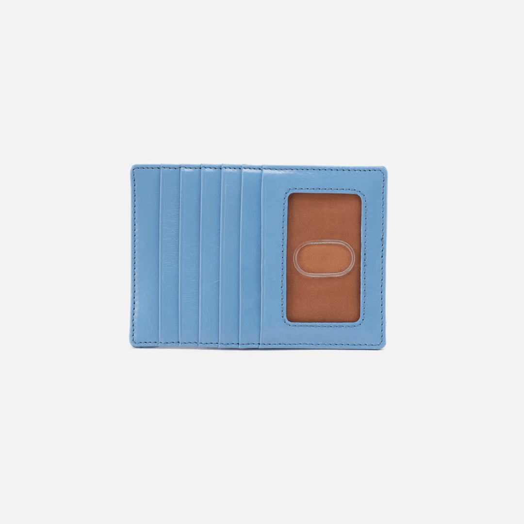 Blue cardholder with a brown interior on a light gray background