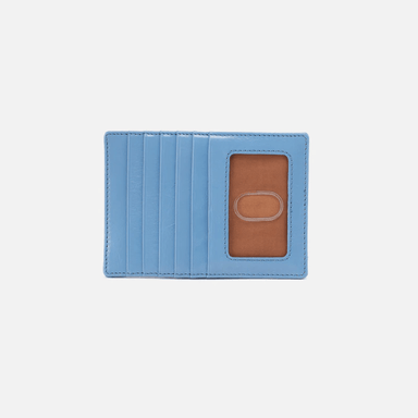 Blue cardholder with a brown interior on a light gray background