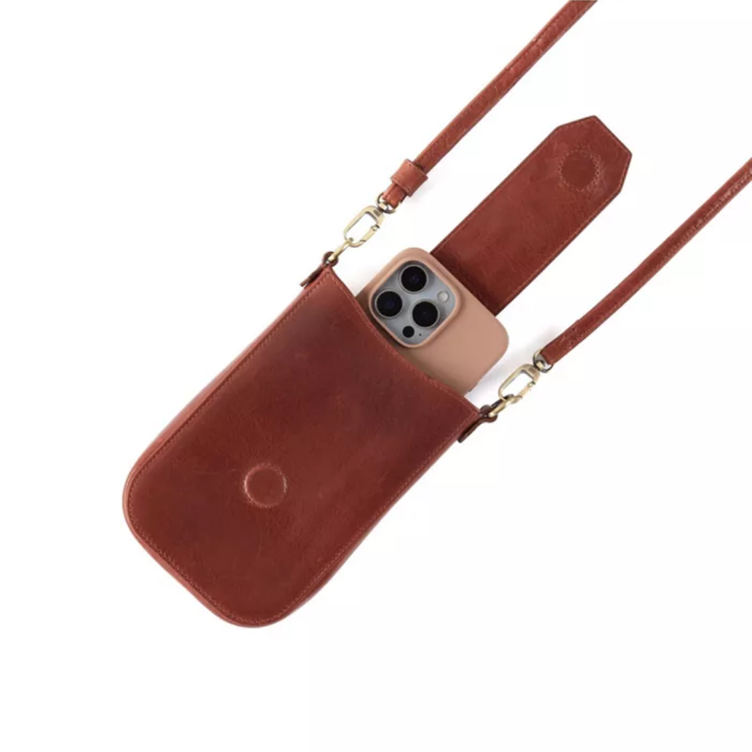 A brown leather crossbody phone pouch with a matching strap, shown holding a beige smartphone on a clean white background.