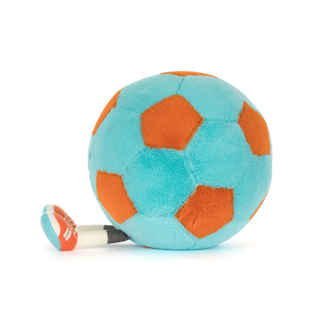 Plush soccer ball showing its orange and blue patterned panels