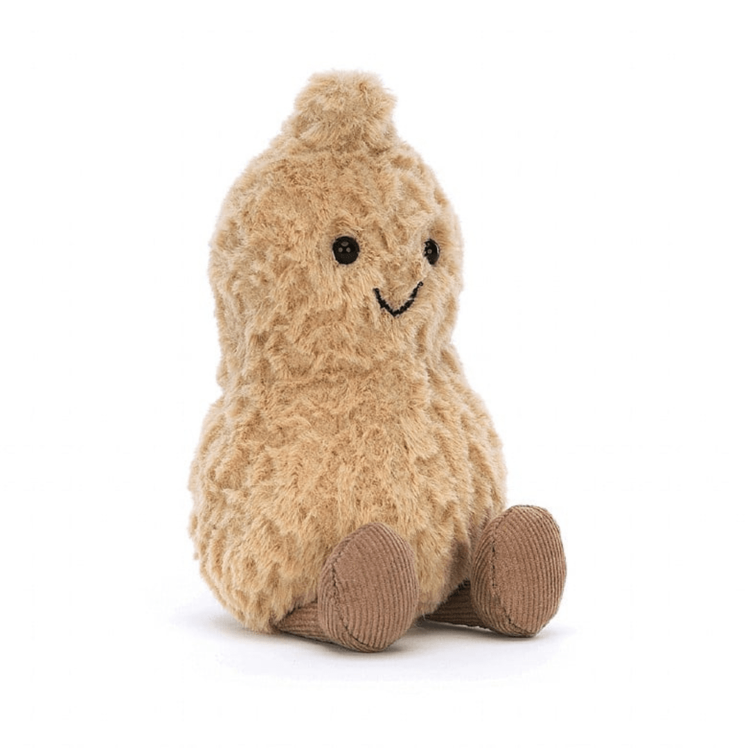 A soft, plush toy resembling a peanut with a smiling face, beige body, and brown boots.