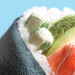Close-up of a textured fabric with green, orange, and white patterns against a blue background