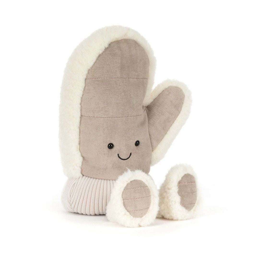 A plush winter mitten toy in a warm taupe-brown fabric with cream sherpa trim, featuring a simple embroidered smiley face and small feet, shown on a clean white background.