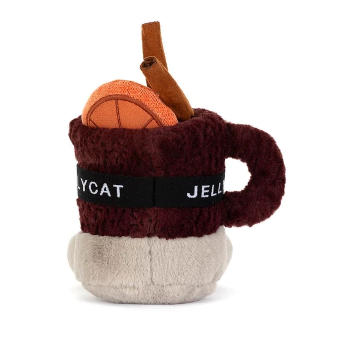 A plush novelty mug toy or pillow featuring a dark burgundy fuzzy body, a black band with white text reading 'JELLYCAT', a light beige bottom, and decorative orange and brown faux-fruit details on top, photographed on a white background.
