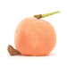 Plush peach toy with a green stem on a white background