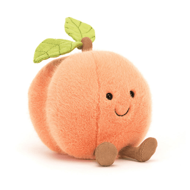 A plush toy peach with a smiling face, halow fur, and a green leaf on top.
