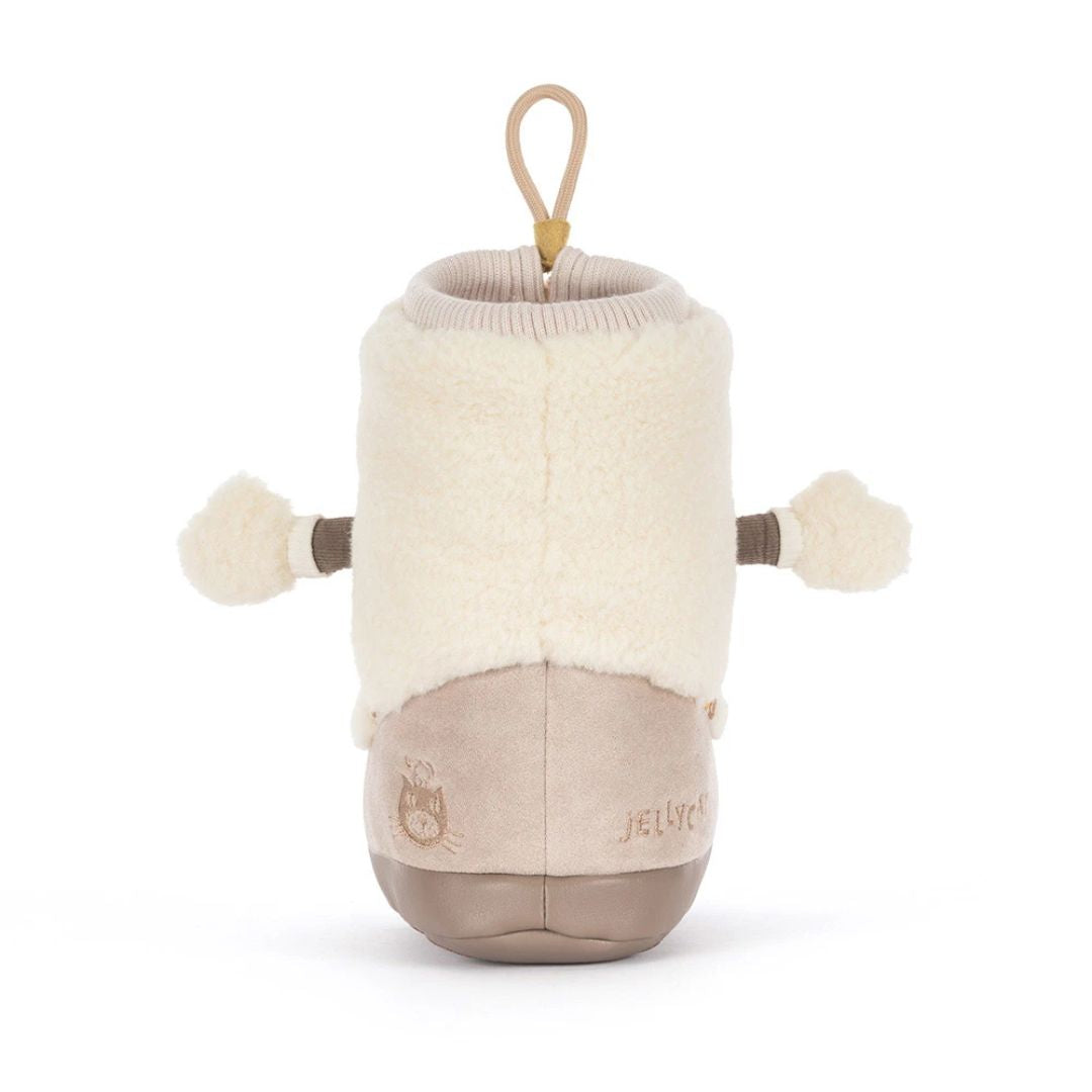 A JELLYCAT plush sheep bootie toy on a clean white background. The toy features a cream-colored fluffy fleece body, brown fabric arms with pom-pom ends, a beige lower body, and a tan hanging loop at the top.