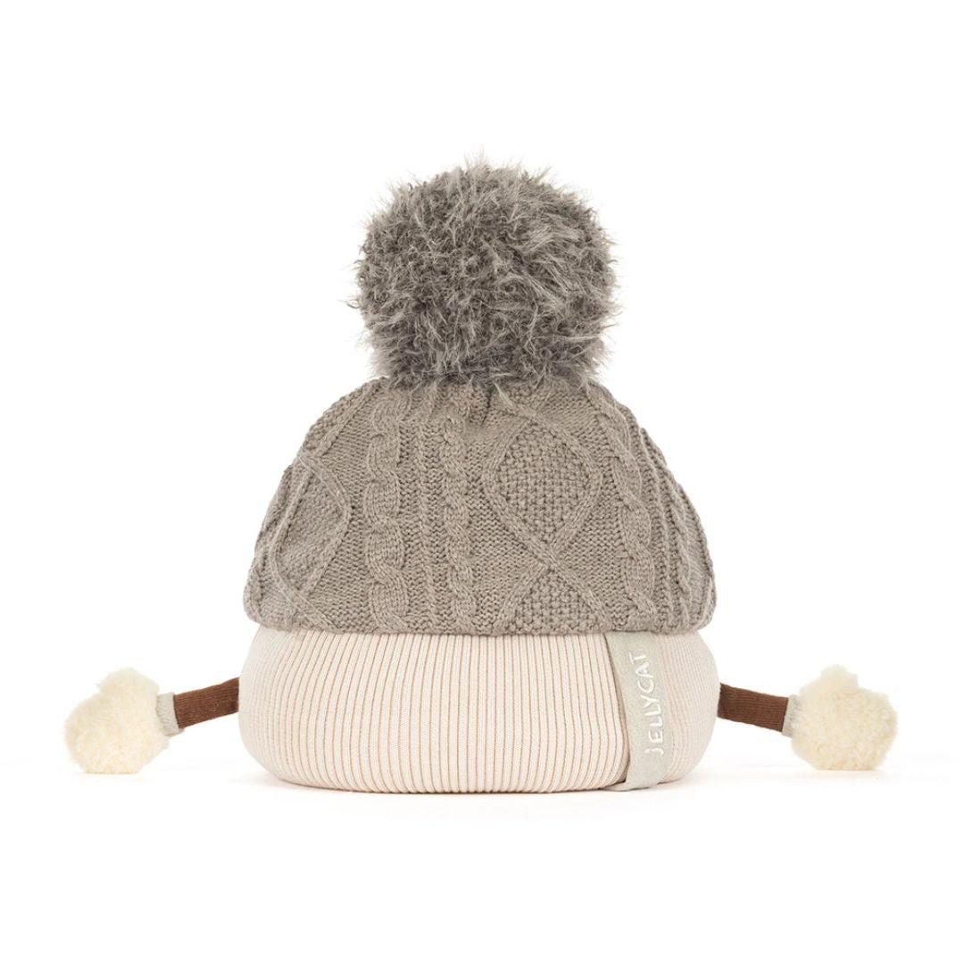 A gray cable-knit beanie hat with a large gray pom-pom on top, a cream ribbed brim, and small cream pom-poms on the sides, photographed on a white background.