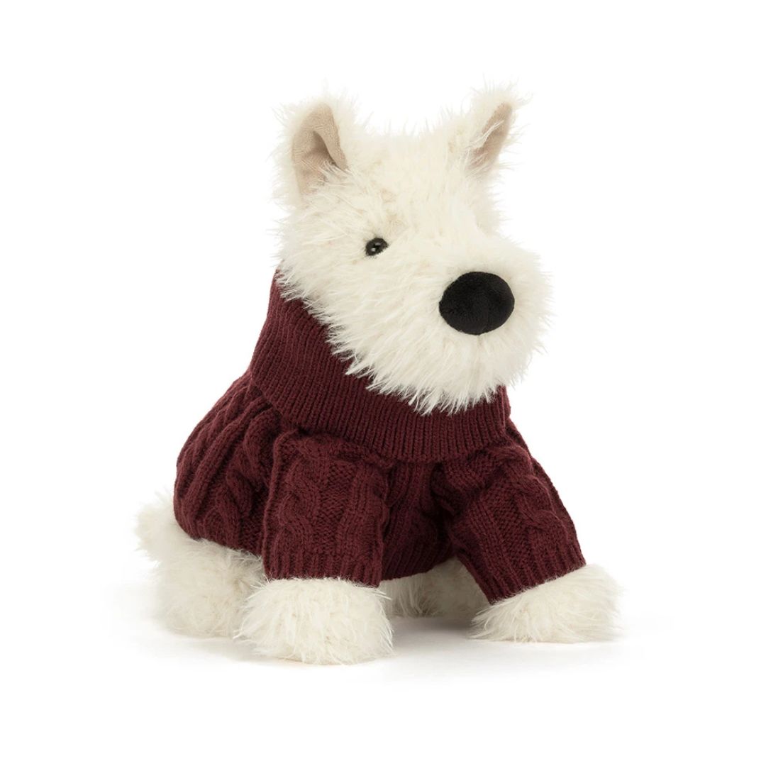 A plush dog toy wearing a burgundy cable-knit sweater, photographed against a seamless white background.