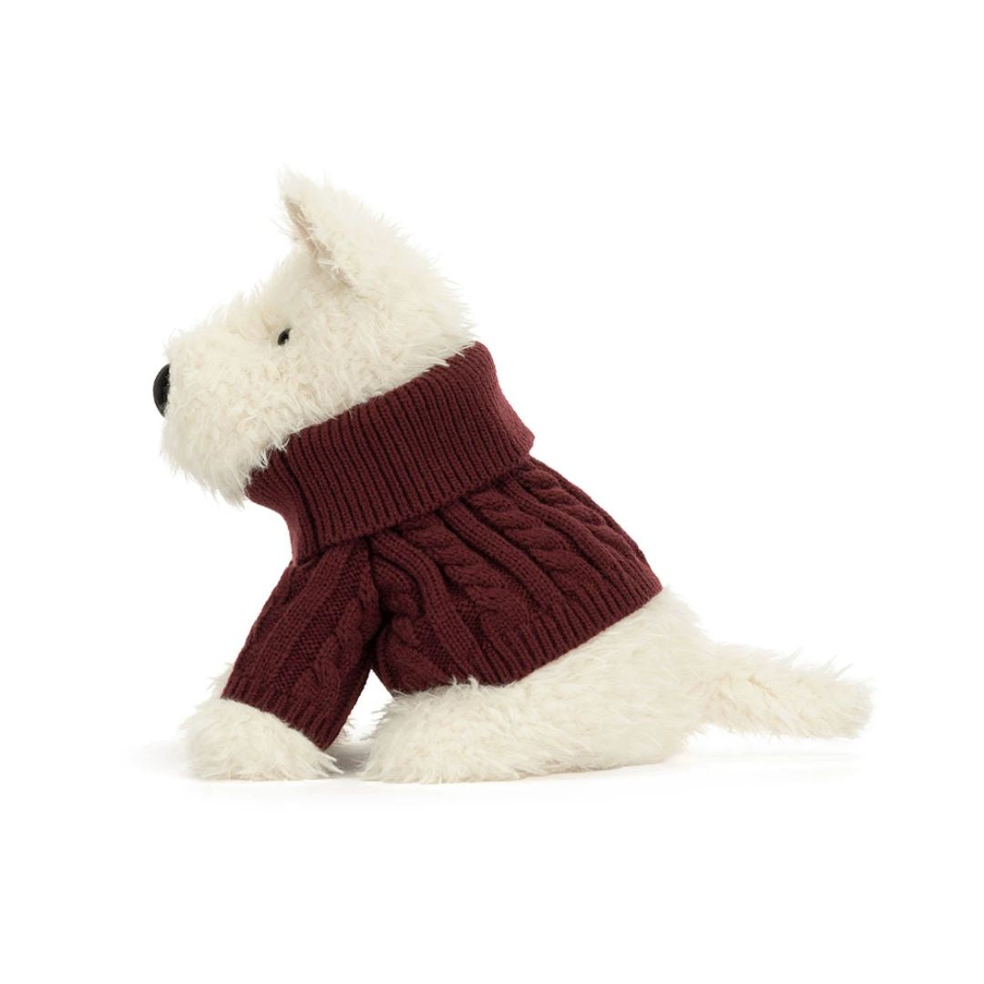 A plush dog toy wearing a burgundy cable-knit turtleneck sweater, photographed on a clean white background.