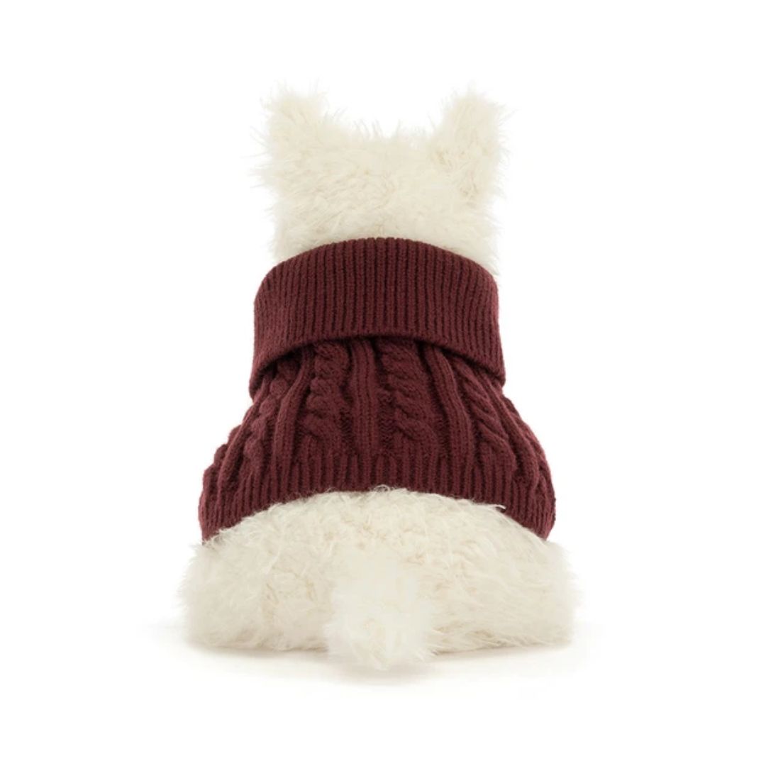 A small white dog viewed from behind wearing a burgundy cable-knit pet sweater with fluffy white faux fur trim on the top and bottom, set against a plain white background.