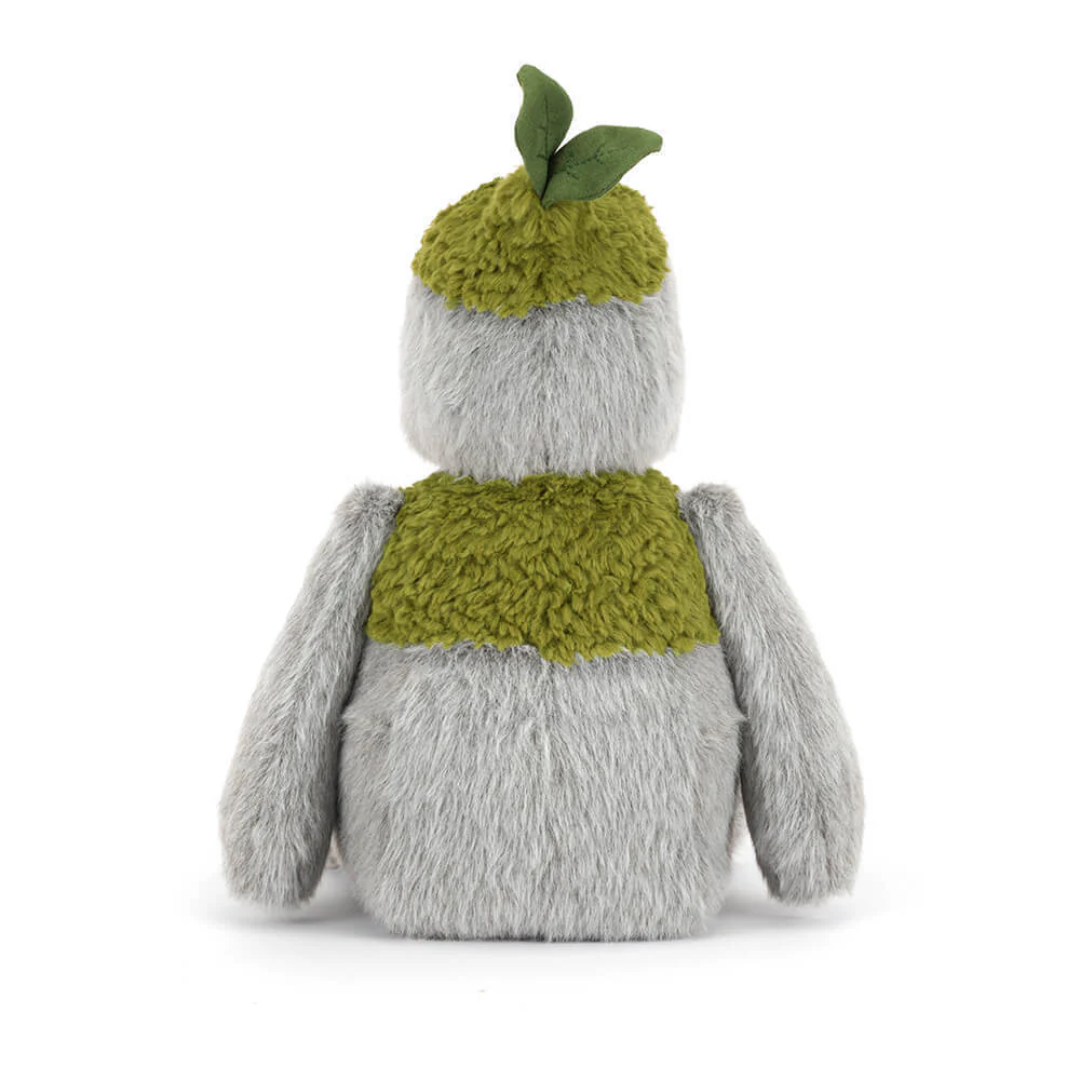 Plush toy resembling a penguin with a green knitted sweater and hat on a white background