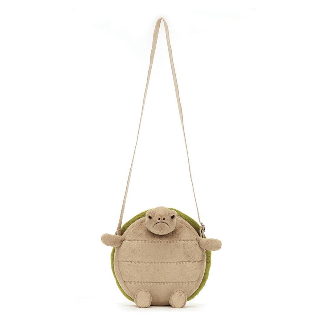 grumpy turtle bag with long strap on plain background