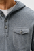 Close-up of a person wearing a heather gray hooded henley shirt with a three-button placket and a chest pocket, layered over a white t-shirt.