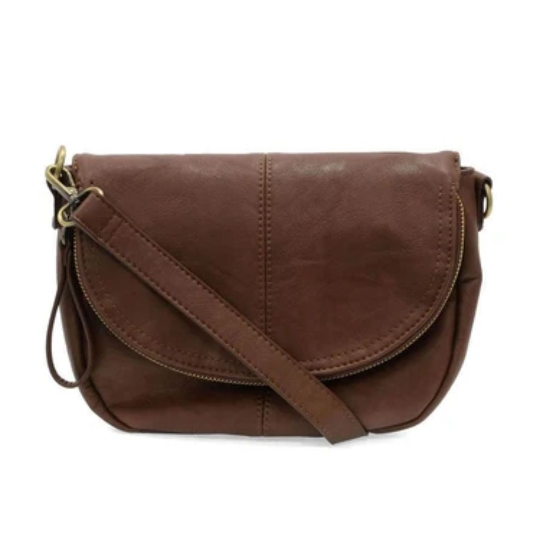 A brown faux-leather crossbody bag with a curved front flap, gold-tone hardware, and a matching adjustable shoulder strap, shown against a plain white background.