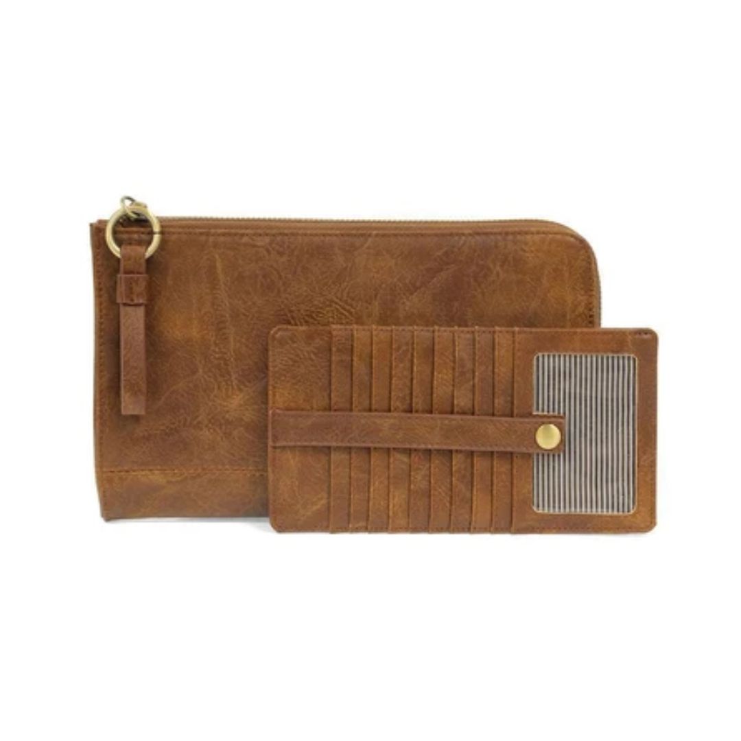 A brown faux-leather zip-around wallet with a wrist strap and gold-tone hardware, shown next to a matching slim card holder wallet with a striped card slot panel, on a white background.
