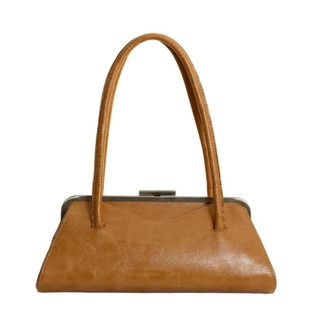A tan leather handbag with a kiss-lock metal clasp and dual top handles, shown against a plain white background.