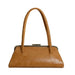 A tan leather handbag with a kiss-lock metal clasp and dual top handles, shown against a plain white background.