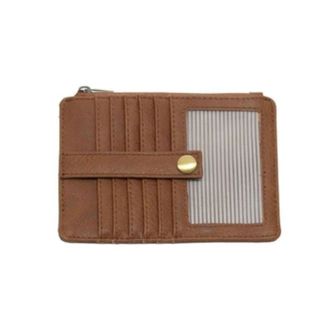 A brown leather zip-around card holder wallet with multiple card slots, a snap-button strap, and a clear ID window showing striped cards inside, set against a plain white background.