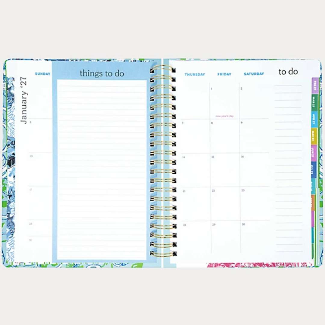 Open planner showing a weekly layout with colorful tabs on a white background