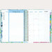 Open planner showing a weekly layout with colorful tabs on a white background