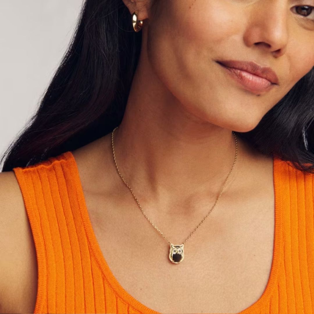 Kendra Scott Owl Pendant Necklace worn by a model in an orange tank top.