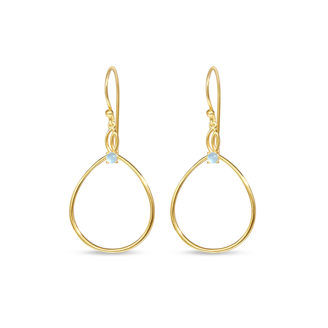A pair of gold teardrop dangle earrings with a small light blue bezel-set stone at the top, shown against a plain white background.
