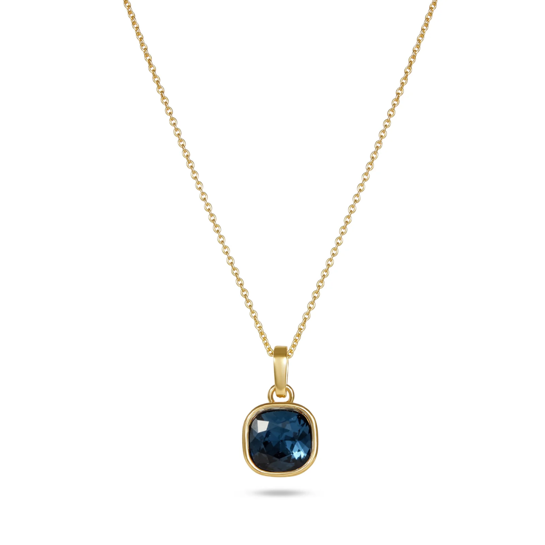 Gold necklace with a blue gemstone pendant on a white background