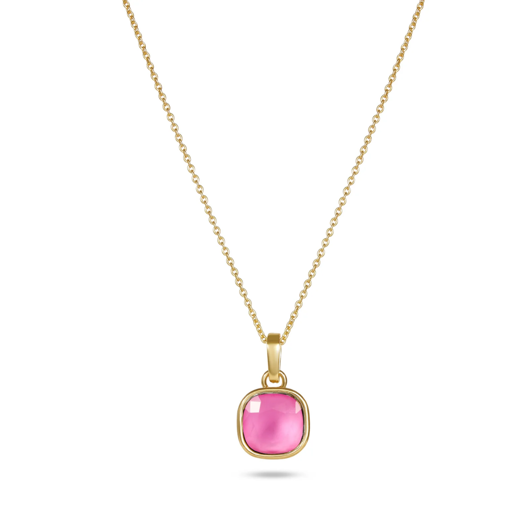 Gold necklace with a pink gemstone pendant on a white background