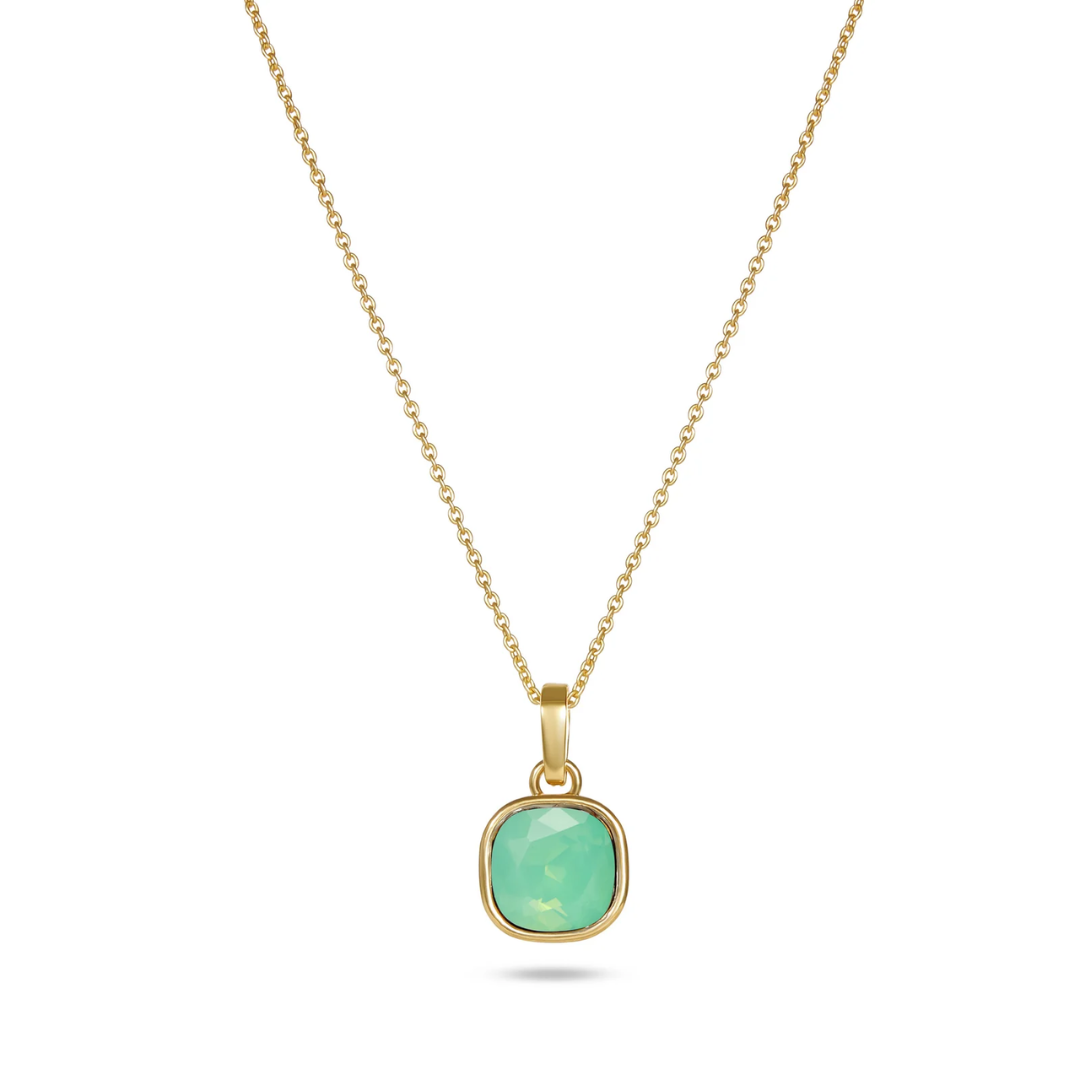 Gold necklace with a green pendant on a white background