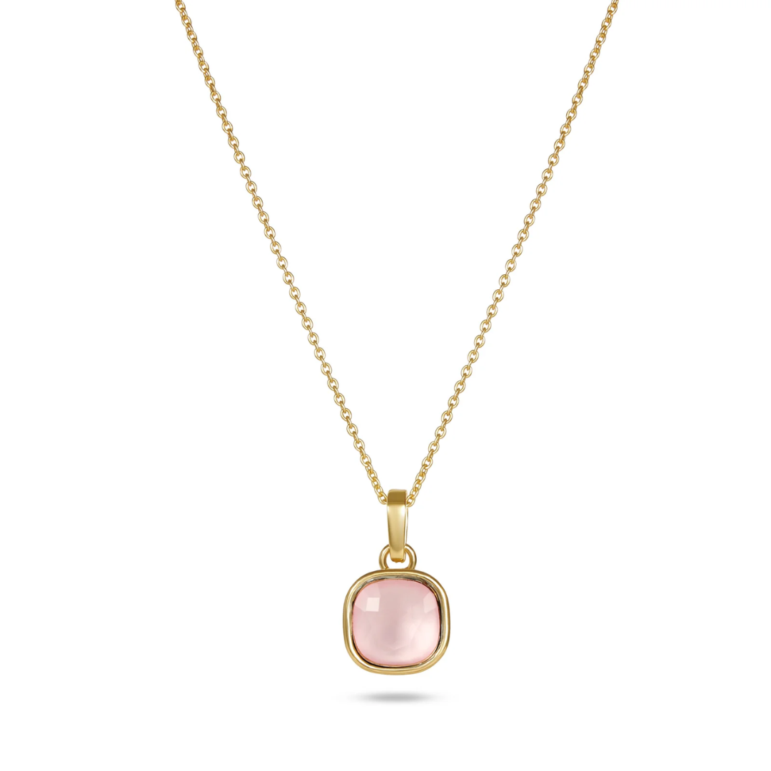 Gold necklace with a pink pendant on a white background