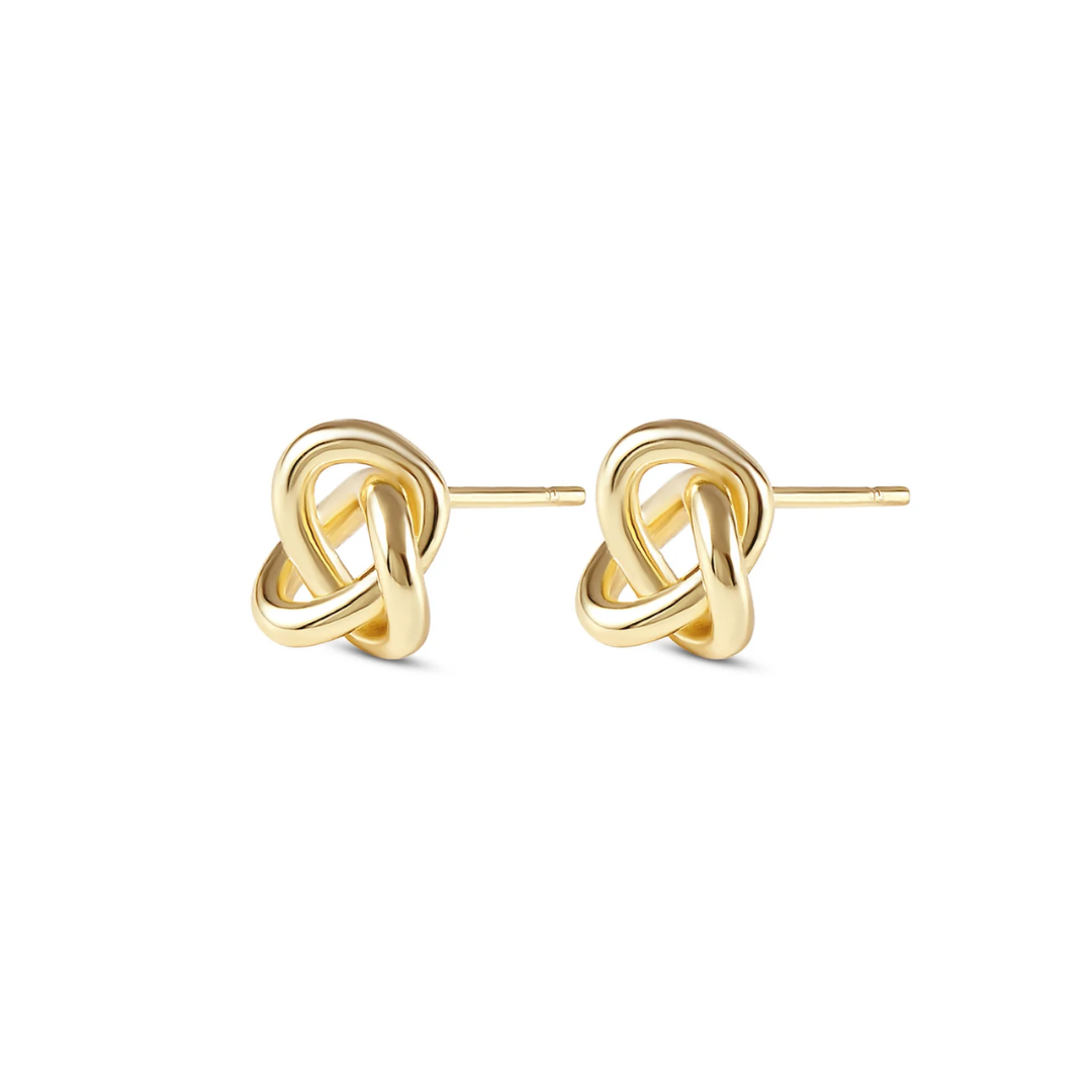 gold knot earings on white background