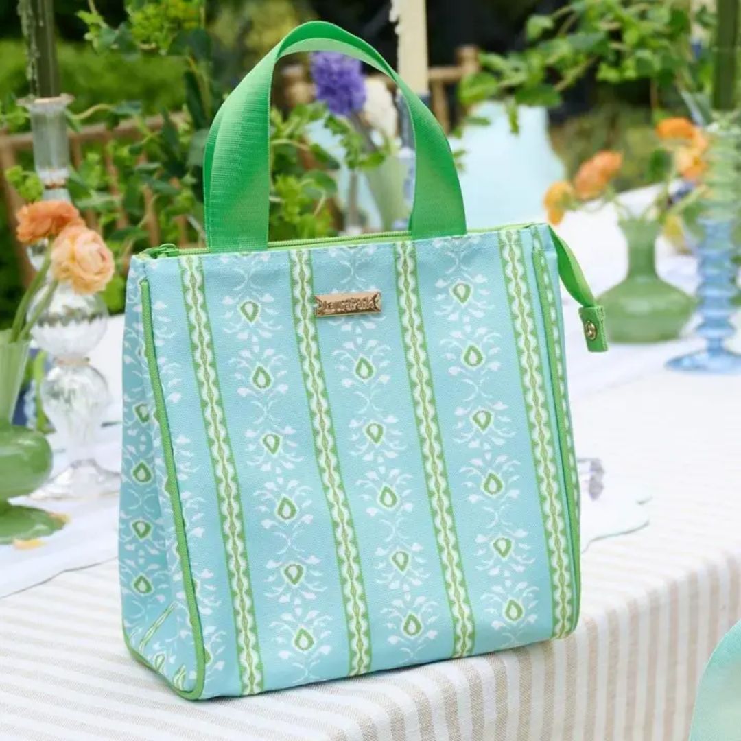 Light blue tote bag with green pattern on a table outdoors