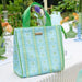 Light blue tote bag with green pattern on a table outdoors