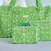 Green floral-patterned bags with matching pouch on a light background