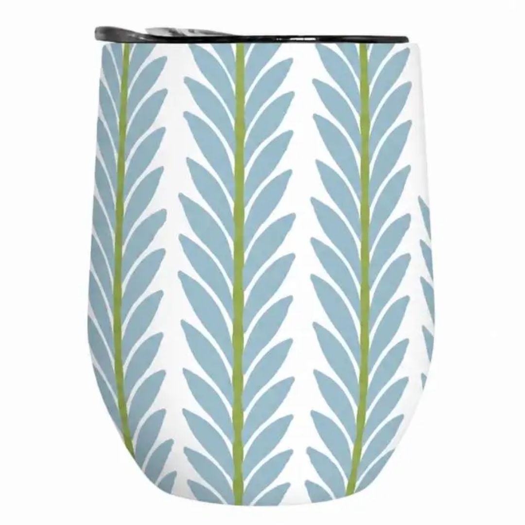 A stemless wine tumbler with a white background and a vertical leaf pattern in light blue and olive green, featuring a black rim.