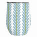 A stemless wine tumbler with a white background and a vertical leaf pattern in light blue and olive green, featuring a black rim.
