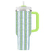Tumbler with a chevron pattern and green handle on a white background