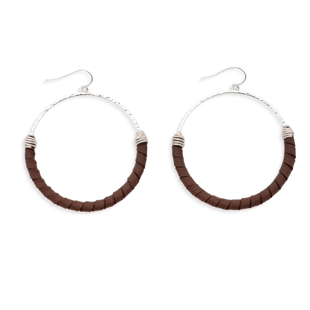 Pair of hoop earrings with brown and silver design on a white background