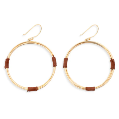 A pair of gold-tone hoop earrings with small brown wrapped accents at the bottom of each hoop, shown on a plain white background.