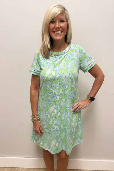 woman wearing blue and green dress with white shells