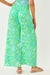 Person wearing a green and blue patterned dress on a white background