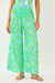 Person wearing a colorful top and pants on a white background