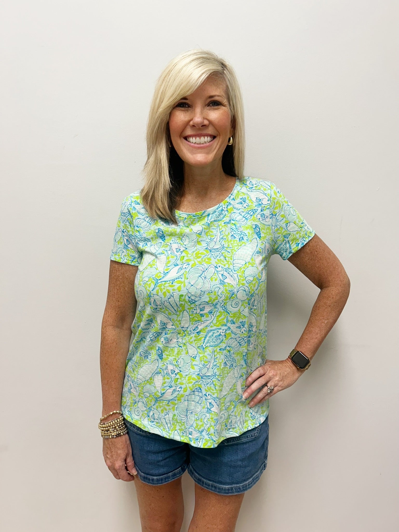 Woman wearing green and blue nautical patterned t-shirt