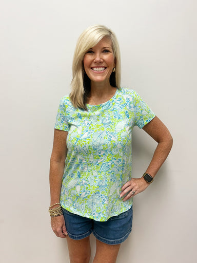 Woman wearing green and blue nautical patterned t-shirt