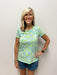 Woman wearing green and blue nautical patterned t-shirt
