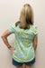 Woman wearing green and blue nautical patterned t-shirt
