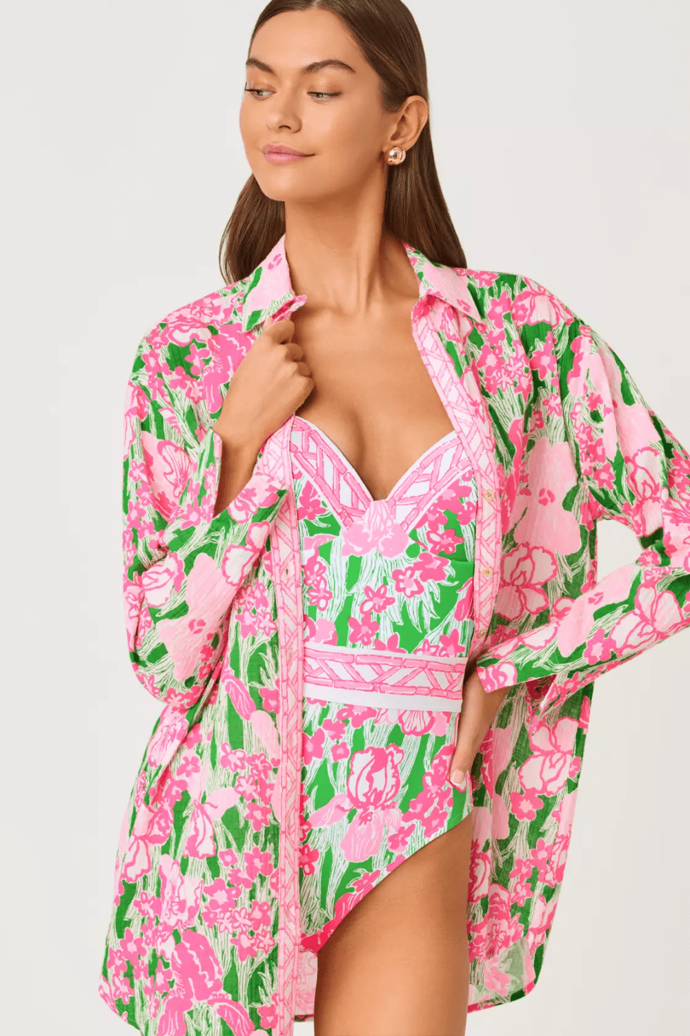 Woman wearing a pink and green floral cover-up on a white background
